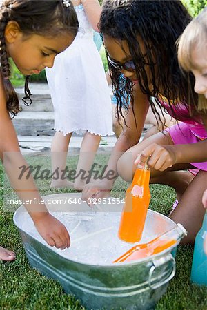children picking sodas out of a bin of ice