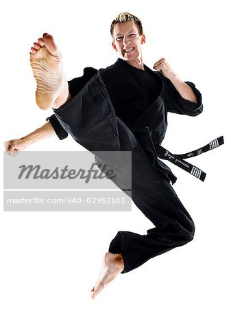 man in a black karate gi practicing martial arts