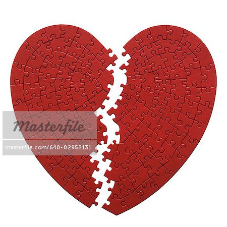 red heart shaped jigsaw puzzle on a white background