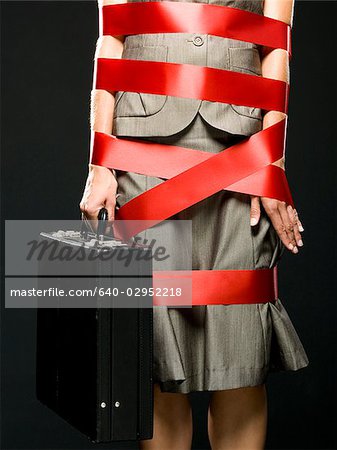 businesswoman all wrapped up in red ribbon
