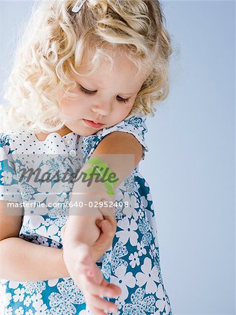 little girl with a bandaid on her arm