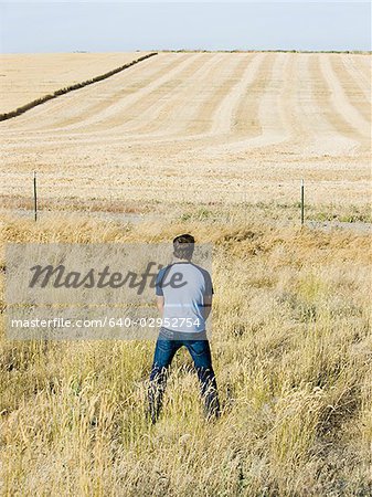 man urinating along the side of road