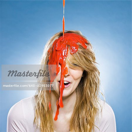 woman getting goo poured on the head