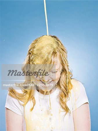 woman getting orange juice poured on her head