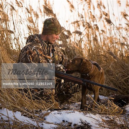 hunter and his dog in a field