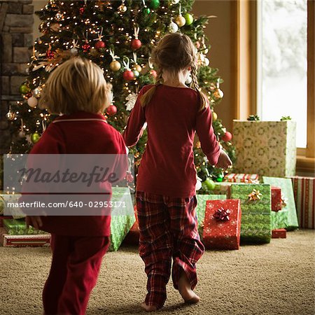 children running to presents on christmas morning