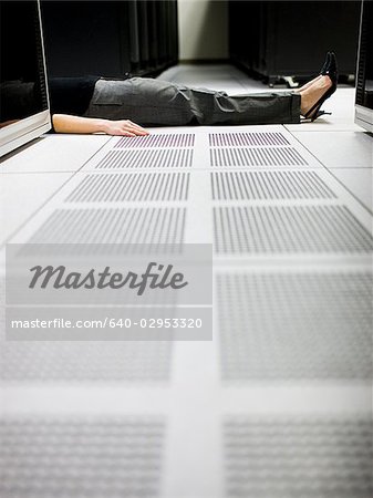 woman lying on the floor of a server room