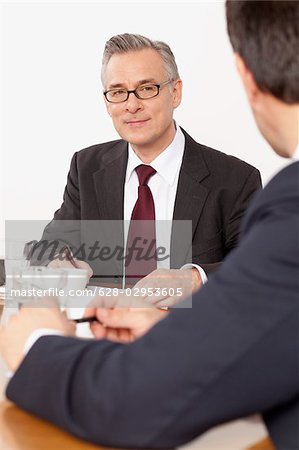 Two businessmen talking in conference room, Munich, Bavaria, Germany