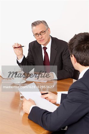 Two businessmen talking in conference room, Munich, Bavaria, Germany