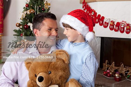 Father with son and teddy at Christmas tree