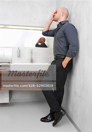 Exhausted businessman in restroom