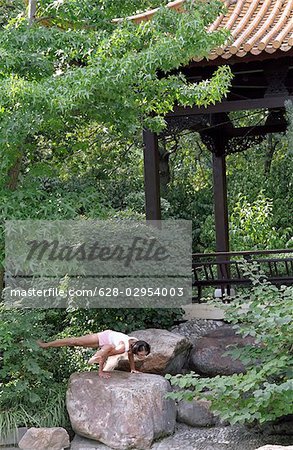 Woman doing Yoga on a Rock - Harmony - Nature - Buddhism