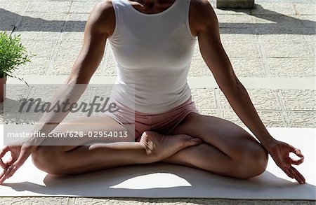 Woman in a  Buddha-Sit-Position  - Yoga - Meditation - Posture