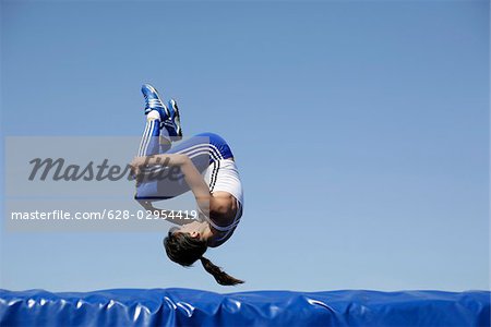 Woman falling on safety mat