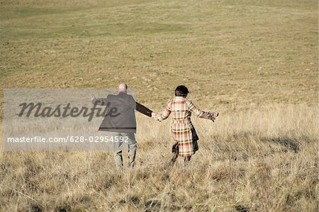 Mature couple walking down a hill