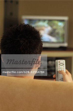 Darkhaired Man watching TV - Media - Relaxation - Living Room
