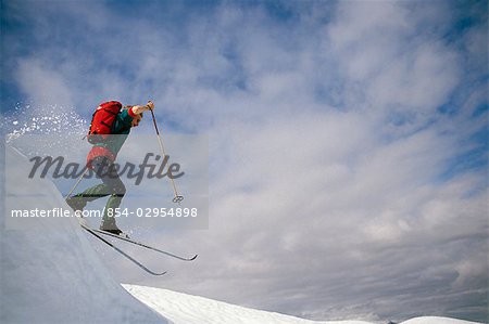 Cross Country Skier Jumping Off Ridgeline SC Alaska