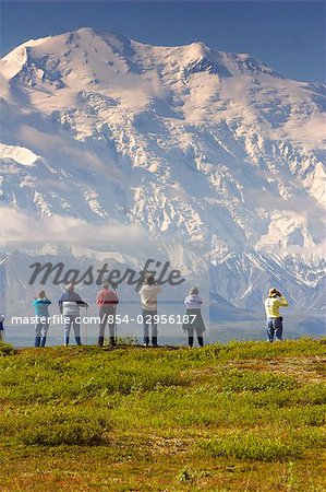 Group of tourists view Mt.McKinley from tundra overlook near Wonder Lake Denali National Park Alaska
