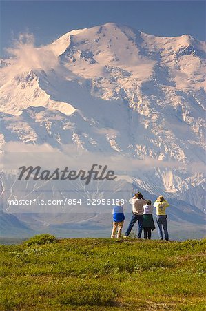 Group of tourists view Mt.McKinley from tundra overlook near Wonder Lake Denali National Park Alaska