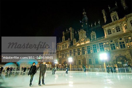 People ice skating in front of the Hotel de Ville at night,Paris,France