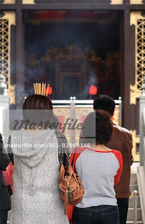 People praying at Wong Tai Sin Temple,rear view,Hong Kong,China