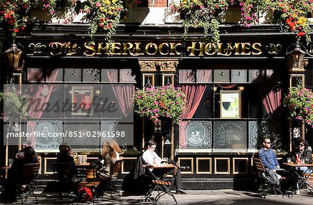 People sitting outside The Sherlock Holmes Pub,London,England,UK
