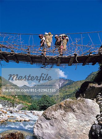 Traverser le pont suspendu, Gurung Porters, région du Dhaulagiri, Népal