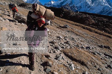 Sherpa carrying heavy load in mountains,Solu-Khumbu,Nepal