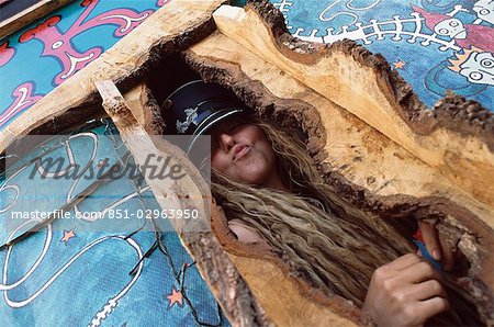 Woman posing in wooden structure,dreadlocks,hate,Glastonbury festival,Glastonbury,Somerset,England,UK