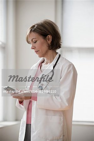 Doctor looking at cellphone