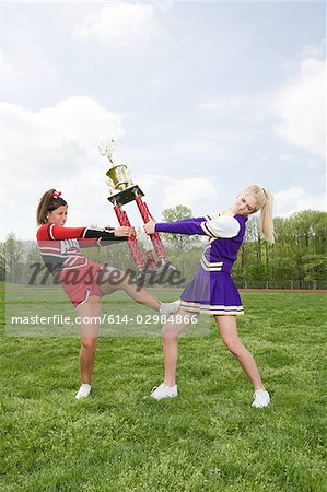 Cheerleaders fighting over trophy