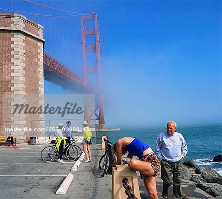 Cyclists meeting at Fort Point National Historical Site, Golden Gate Bridge, San Francisco