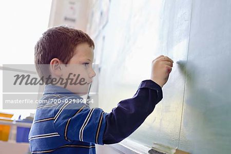 Student Writing on Chalkboard