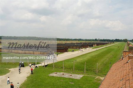 Wooden sheds, formerly stables for horses, that each held 500 prisoners, many now demolished, but chimneys still stand in the background, Auschwitz second concentration camp at Birkenau, UNESCO World Heritage Site, near Krakow (Cracow), Poland, Europe