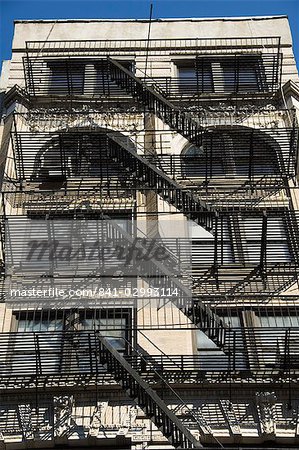 Fire escapes on the outside of buildings in Spring Street, Soho, Manhattan, New York City, New York, United States of America, North America