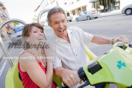 Couple on Vacation Riding Scooter