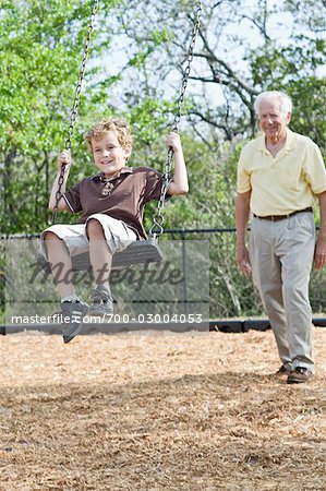 Grandfather Pushing Grandson on Swing