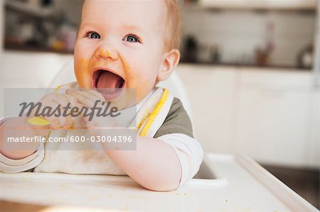 Baby in High Chair Eating