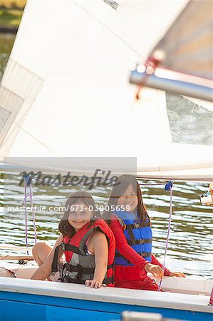 Two girls sailing small boat