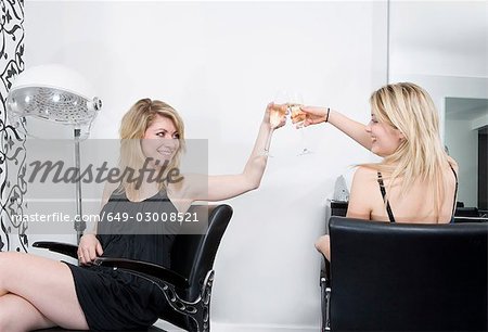 Frauen an Friseure mit Champagner
