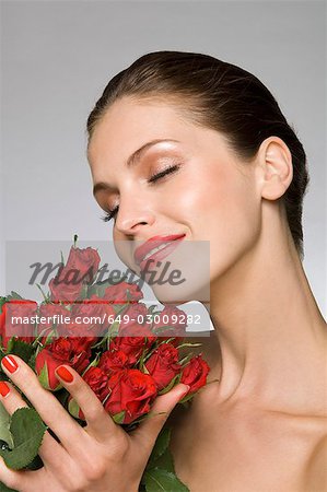 Female beauty model smelling roses