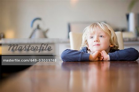 Junge auf der Suche über Tabelle-Rand