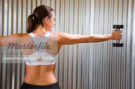 Woman Working out with Dumbbell in Gym, Seattle, Washington, USA