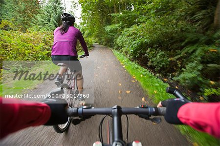 Women Riding Bikes in Forest, Seattle, Washington, USA