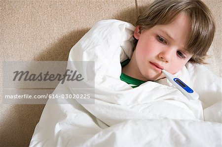 Boy with thermometer in mouth