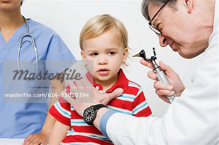 Doctor looking in boys ear