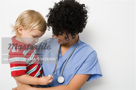 Nurse holding toddler