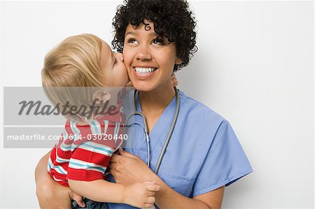 Little boy kissing nurse