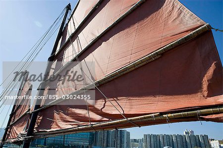 Chinese junk Dukling in Victoria Harbour with Hung Hom skyline at background Hong Kong