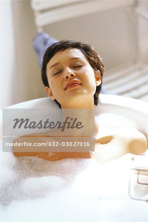 Woman taking bubble bath, relaxing